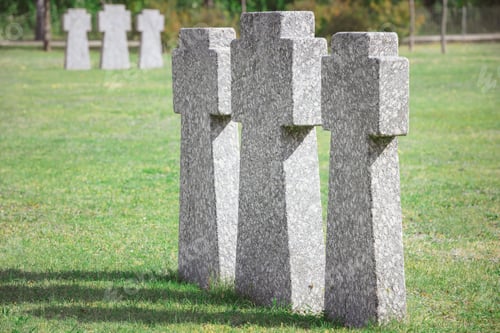 Preview: identical old memorial headstones placed in row at graveyard