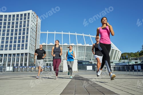 Preview: Happy young mixed racial team running during training