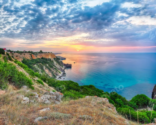 Preview: Unbelivable sunset at cape Fiolent with bushes grass and rocks at foreground.