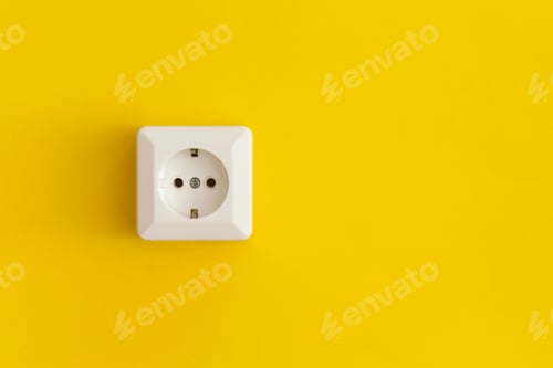 White Electrical Outlet on Bright Yellow Wall