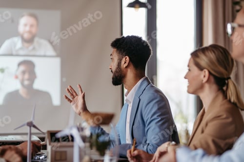 Preview: Young colleagues having meeting, consulting about green energy.