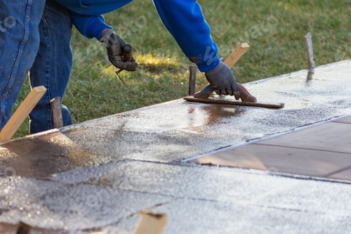 Preview: Construction Worker Smoothing Wet Cement With Trowel Tools