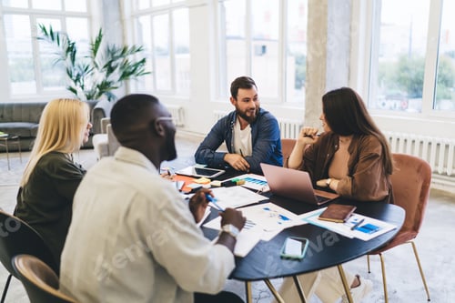Preview: Group of coworkers working on project in office