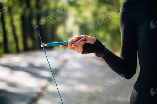 Preview: Close up view of woman with jump rope outdoors