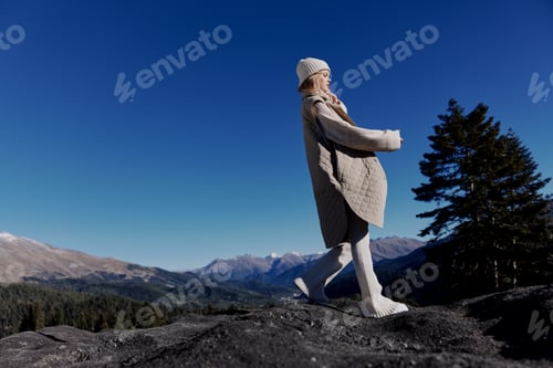 Preview: tourist in autumn clothes stands on a rock landscape blue sky landscape