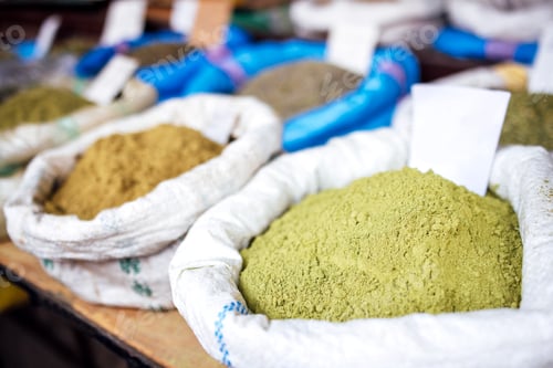 Preview: Colorful assortment of spices in burlap sacks displayed at a market