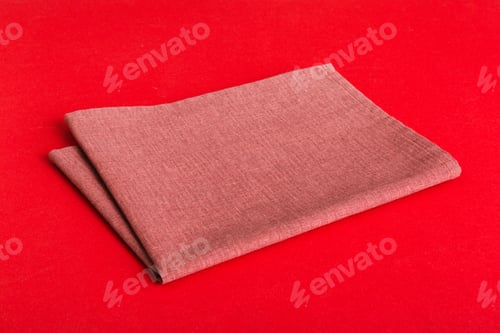Preview: top view with red empty kitchen napkin isolated on table background. Folded cloth for mockup