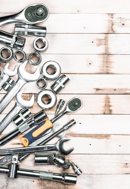 Preview: Collection of metallic tools arranged on a wooden surface ideal for DIY tasks and repairs