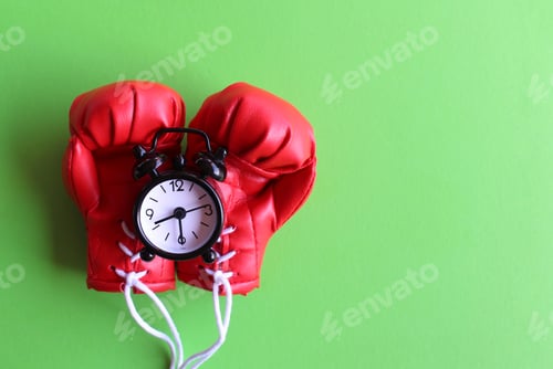 Preview: Boxing gloves and alarm clock on green background.