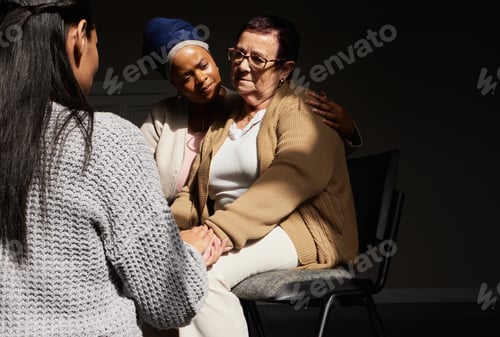 Preview: Support, holding hands and senior woman in group therapy with women understanding, sharing feelings
