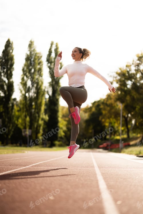 Preview: Female Athlete Jumping On Track
