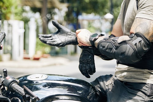 Preview: Man On Motorcycle Putting On Leather Gloves