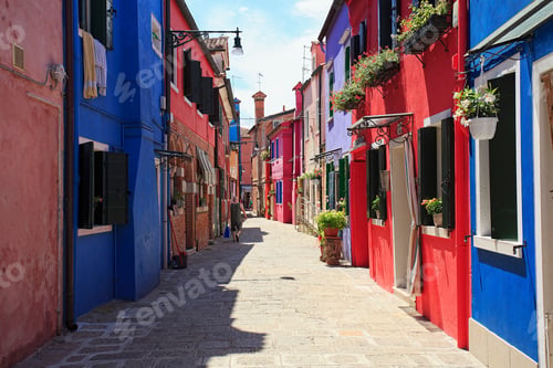 Preview: Scenic view of a narrow street between colorful buildings on a sunny day in Burano, Venice, Italy