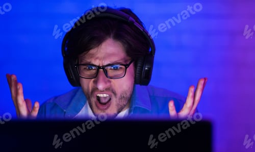 Preview: Gamer Shouting And Gesturing Having Low Internet Sitting Indoor, Low-Light