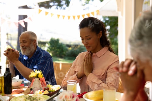 Preview: Family eating together at table