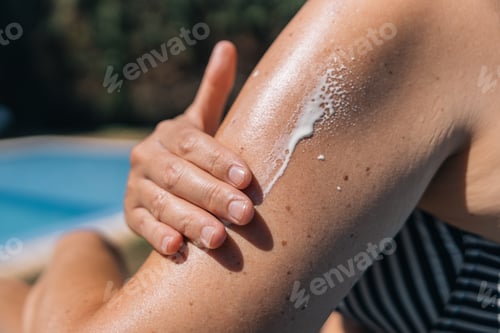 Preview: Close-up of a woman's hand applying sunscreen, concept of prevention and skin care
