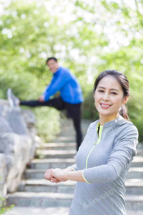 Preview: Happy mature woman exercising in park
