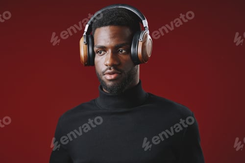 Preview: Focused young man wearing stylish headphones, showcasing a modern vibe and deep concentration