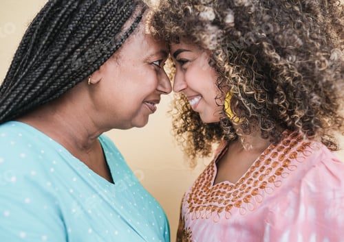 Preview: African mother and daughter with fore a head together having tender moment
