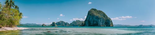 Preview: Tropical panorama scenery of coastline with huge rocky island on the background. National Marine