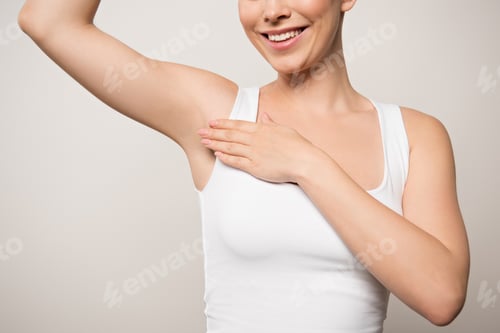 Preview: partial view of joyful woman applying deodorant on underarm isolated on grey