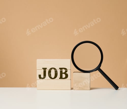 Preview: Wooden cubes with the inscription work and a black magnifier on a white table