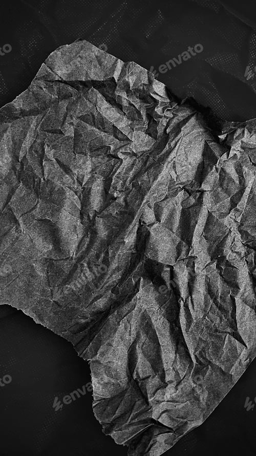 Preview: Crumpled paper on a dark background.
