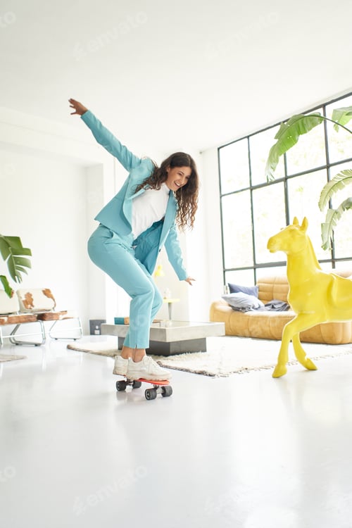 Preview: Vertical photo of business woman riding skateboard in office worker outfit at home