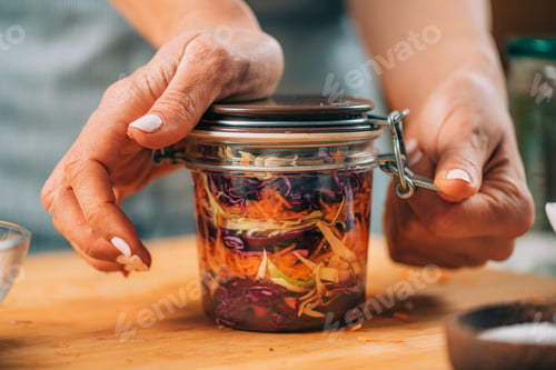 Preview: Woman Holding a Jar with Fermented Vegetables.