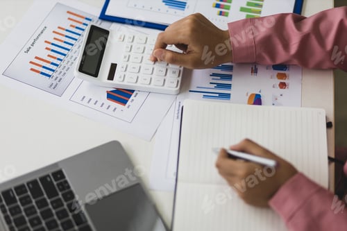 Preview: Calculation and analysis of financial statement accounting data on the desk.