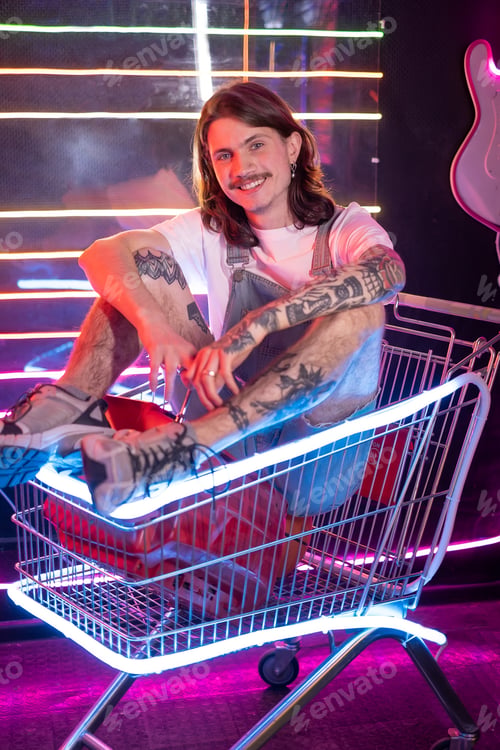 Preview: Millennial man sitting in shopping cart and feel nostalgia for retro style