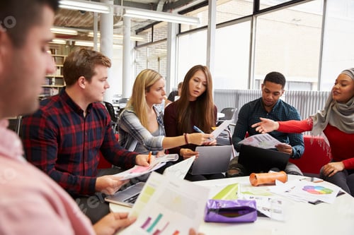 Preview: Group Of Students In Library Collaborating On Project