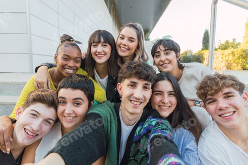 Preview: Happy friends taking selfie near entrance of modern building