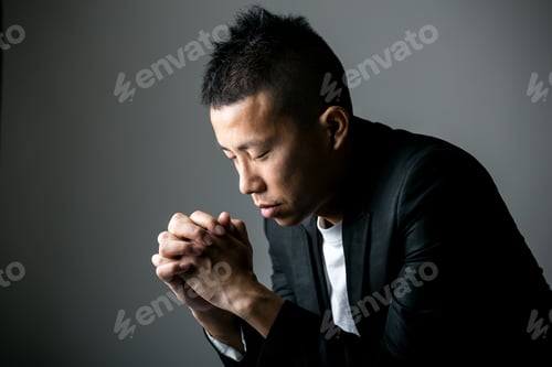 Man in Thoughtful Pose Wearing Suit Jacket