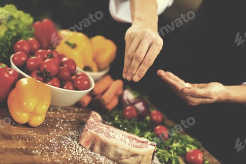 Preview: Chef putting salt on juicy slice of raw steak