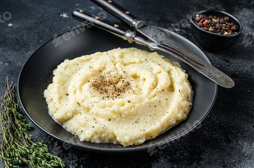Preview: Potato puree, Mashed potatoes in a plate with herbs. Black background. Top view