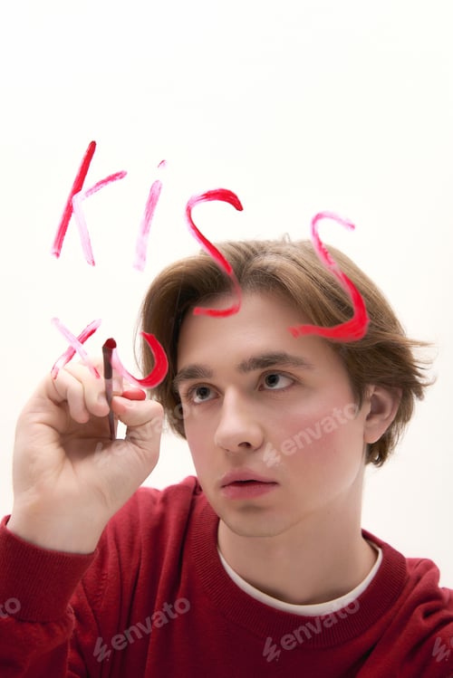 Preview: Young stylish man writing a message on a clear surface, capturing a moment of creativity