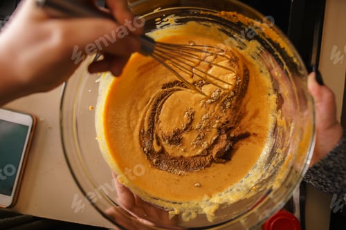 Preview: pumpkin pie recipe concept - woman whisking in cinnamon and spices for batter shot from pov view