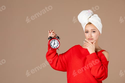 Preview: front view young female with clocks and towel on her head on pink background woman hair shower time