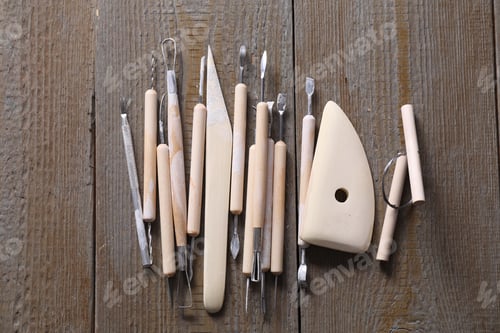Preview: Set of different clay crafting tools on wooden table, top view