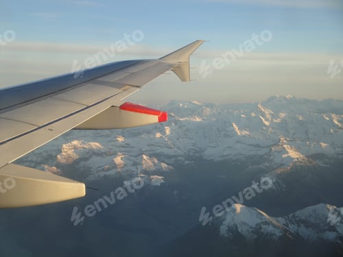 Preview: Closeup of an airplane wing flying over the alps from Madrid to Zurich