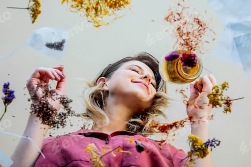 Preview: young girl from under glass table while she prepares leaves before brew a tea