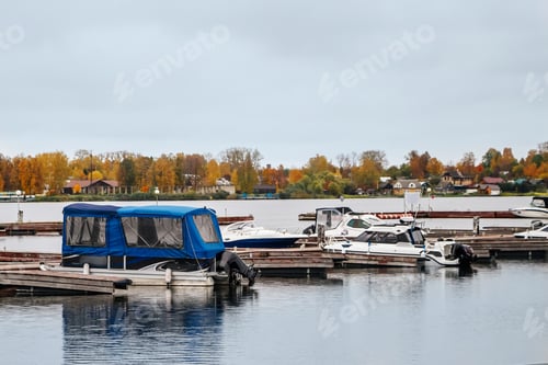 Preview: Boats at the pier in the autumn on cloudy afternoon.