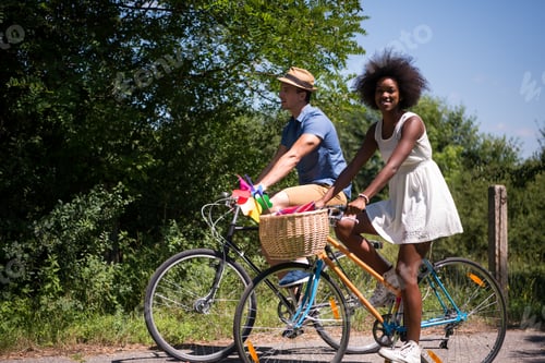 Preview: Young multiethnic couple having a bike ride in nature