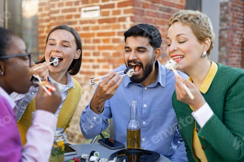 Preview: Friends Enjoying Sushi Outdoors