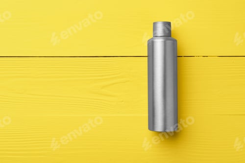 Preview: Gray cosmetic bottle on yellow wooden background