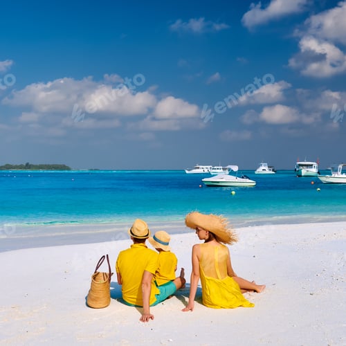 Preview: Family On Beach, Young Couple In Yellow With Three Year Old Boy. Summer Vacation At Maldives.