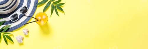 Summer Drink with Beach Accessories on Yellow Background