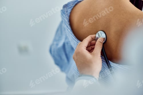 Preview: Medical Examination with Stethoscope on Patient's Back in Healthcare Setting