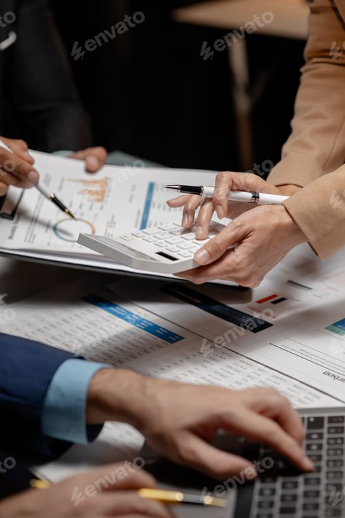 Preview: A group of three businesspeople are working together to calculate the company's numbers, employees a